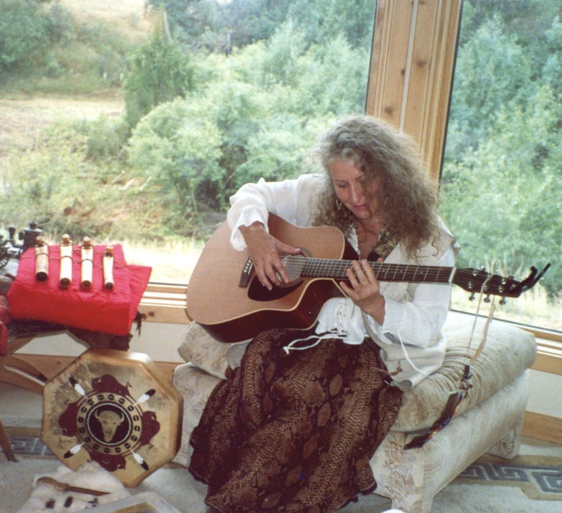 Bunny playing acoustic guitar by a sunlit window
